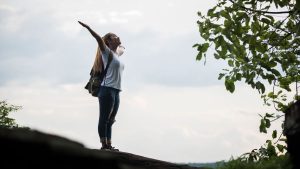 happy woman with arms out celebrating personal growth