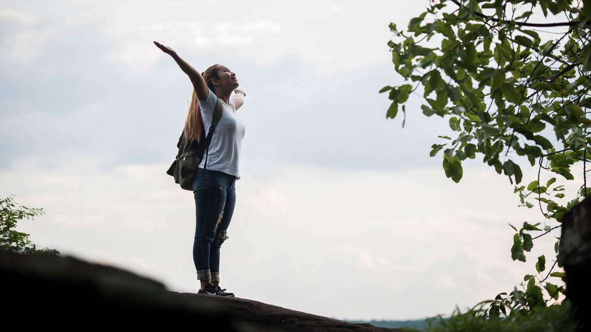 happy woman with arms out celebrating personal growth